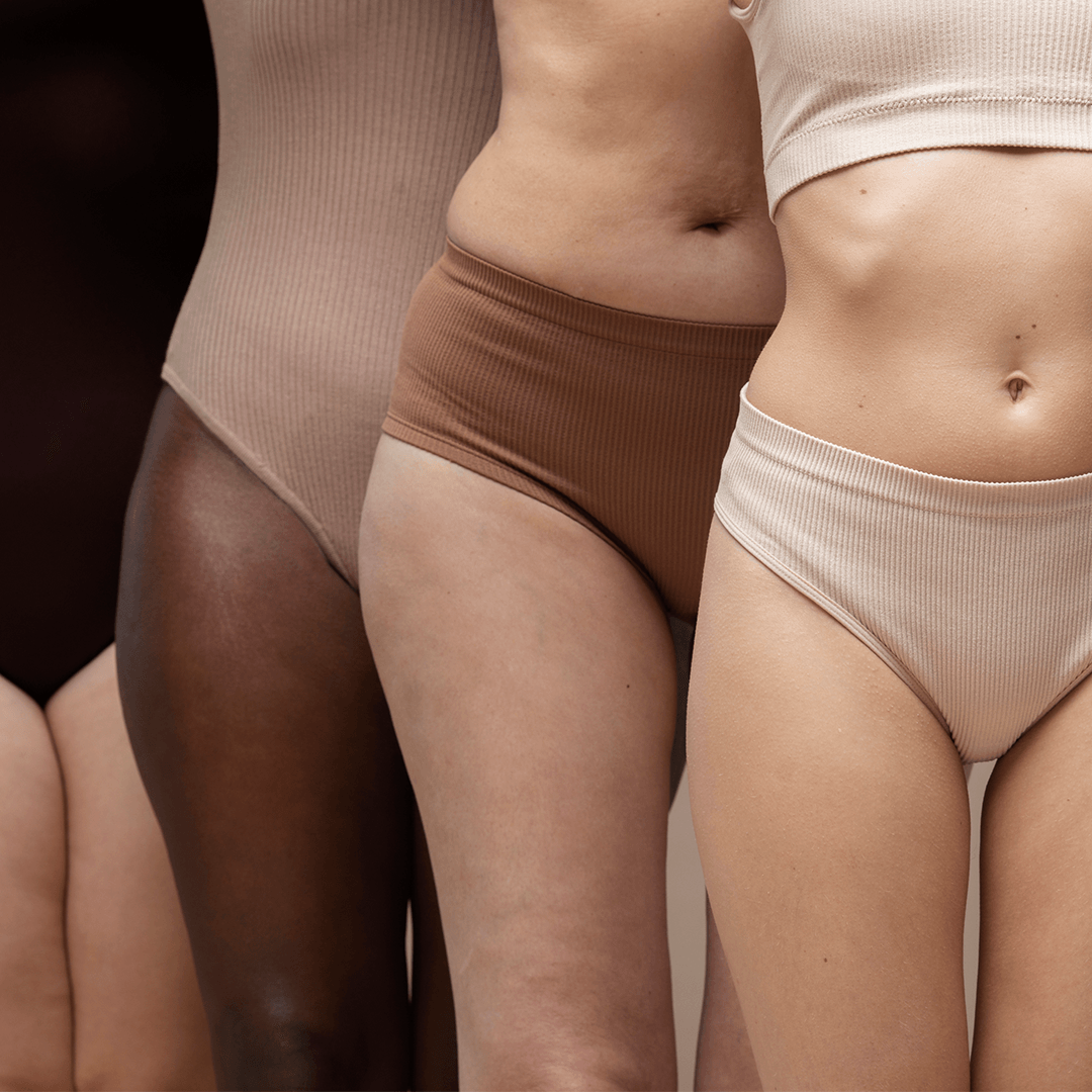 Woman Standing with Assorted Period Underwear Depicting Eco-Friendly Production for Heralogie Period Undies